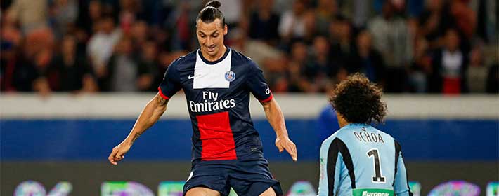 Paris Saint-Germain's Ibrahimovic challenges Ajaccio's Ochoa during their French Ligue 1 soccer match at Parc des Princes stadium in Paris