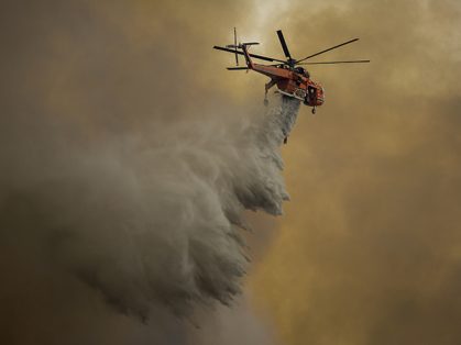 BURBANK, CA - SEPTEMBER 02: An Erickson Air Crane firefighting helicopter drops water over the La Tune Fire on September 2, 2017 near Burbank, California. Los Angeles Mayor Eric Garcetti said at a news conference that officials believe the fire, which is at 5,000 acres and growing, is the largest fire ever in L.A. People have been evacuated from hundreds of homes in Sun Valley, Burbank and Glendale. About 100 Los Angles firefighters are expected to return soon from Texas, where they've been helping survivors from Hurricane Harvey. David McNew/Getty Images/AFP